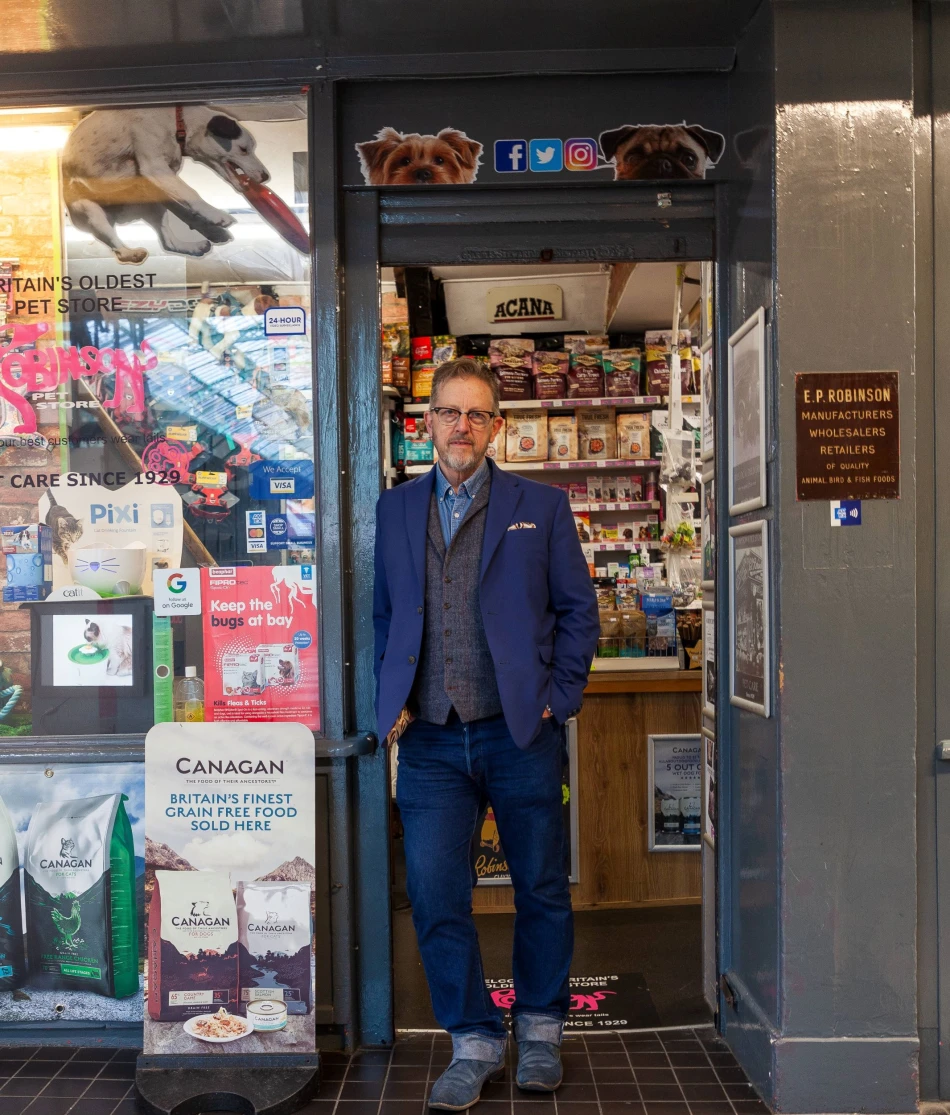 Nick Robinson standing outside of Robinson's Pet Store in Grainger Market