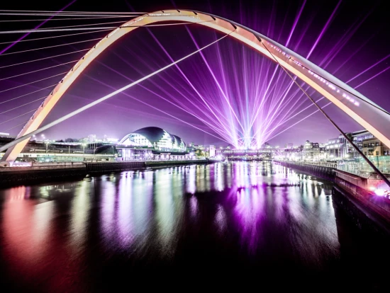 The quayside at night as Laser Light City illuminates the River Tyne and its bridges