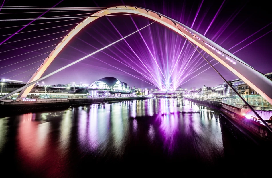 The quayside at night as Laser Light City illuminates the River Tyne and its bridges