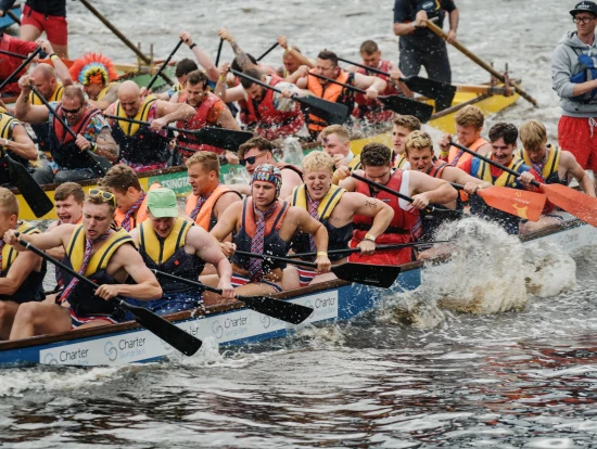 Boats racing side by side on the River Tyne during the Dragon Boat Race