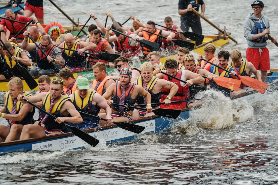 Boats racing side by side on the River Tyne during the Dragon Boat Race