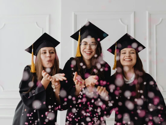 Women in Graduation Gowns and Caps Blowing Confetti by Photo by Kaboompics.com via Pexels