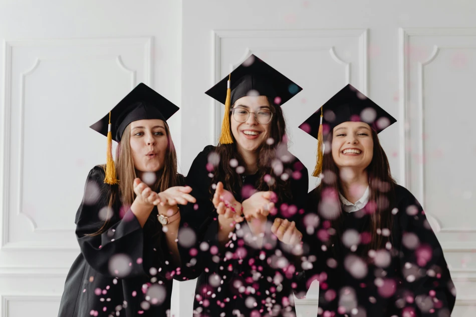 Women in Graduation Gowns and Caps Blowing Confetti by Photo by Kaboompics.com via Pexels