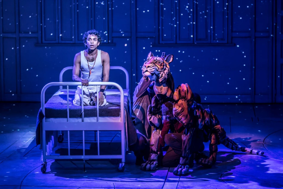 Hiran Abeysekera (Pi) and Richard Parker the Tiger in Life of Pi. Photo by Johan Persson